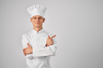 male chef in uniform shows a finger to the place free