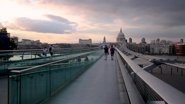footage of the millenium bridge during sunset leading to St Paul's cathedral