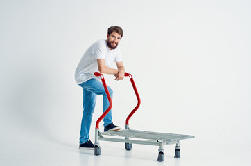 man stands in a trolley on a white background