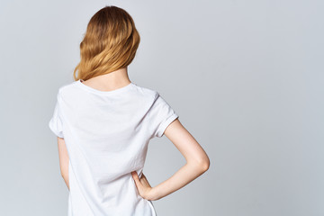Fototapeta premium woman in white t-shirt stands with his back to the camera