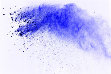 Abstract of blue powder explosion on white background. Blue powder splatted isolate. Colored cloud....