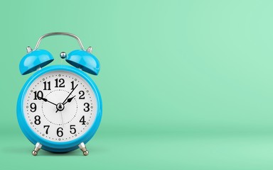 Blue Retro alarm clock on wooden table