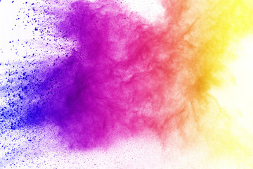 Freeze motion of colored powder explosion isolated on black background. Abstract of Multicolor dust...