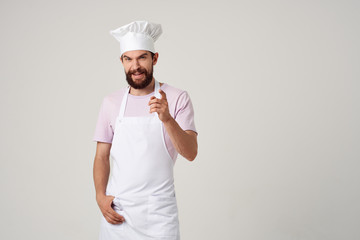 cook man in apron cap on light background