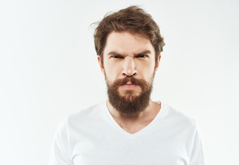 serious man with a beard on a light background portrait