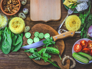 food ingredients - mushrooms, cheese, spaghetti - nests. wooden plank. place for text.