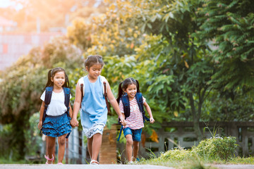 Back to school. Asian  pupil kids with backpack going to school together in vintage color tone