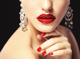 Beautiful lips close up. Red  lipstick. Black background.