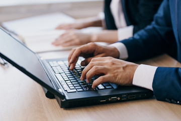 hands typing on laptop