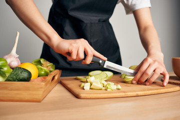 woman cutting vegetables in kitchen