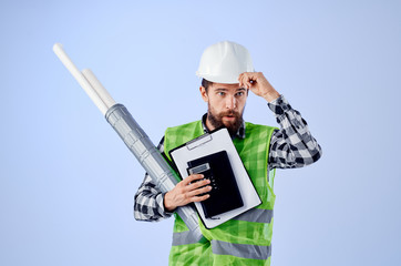 architect with documents in hands in a white helmet