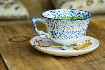 A cup of green tea on a decorated porcelain cup.