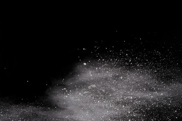 Launched white powder, isolated on black background.