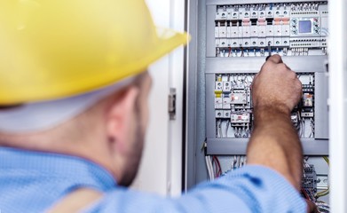 Hand of an electrician with multimeter probe