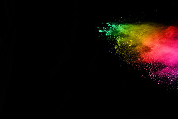 Obraz premium abstract colored dust explosion on a black background.abstract powder splatted background,Freeze motion of color powder exploding/throwing color powder, multicolored glitter texture.