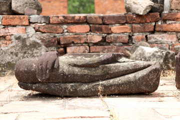 Lap part of the stone Buddha, so ruins and ancient on brick floor at Wat Worachet temple, it built in 1593 AD in the Ayutthaya period.