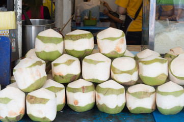 young peeled coconuts stacked in order on sale