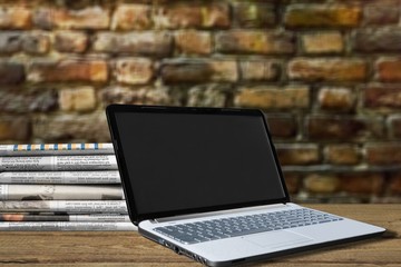 Laptop and book on background.