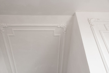 unfinished plaster molding on the ceiling and walls. decorative gypsum finish. plasterboard and...