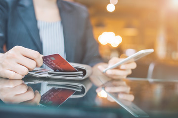 Business women hand are pulling a credit card out of a wallet.