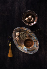 Obraz na płótnie Canvas Retro still life with cup coffee and sugar on antique tray, top view