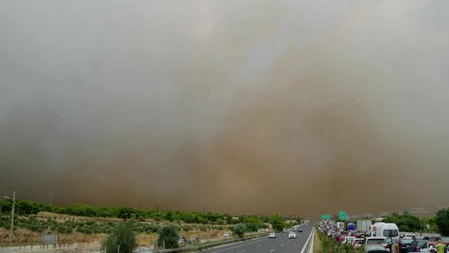 During the wildfires in Attica Greece. View of the smoke from the highway and Skycrane helicopter firefighting.