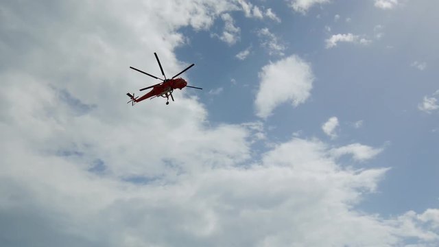 During the wildfires in Attica Greece. View of the smoke from the highway and Skycrane helicopter firefighting.
