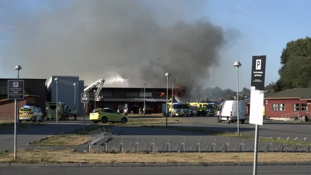 4k Footage of fire at school in very sunny and warm day in Norway, Akershus, Lillestrom.
Fireman department and police is trying to take out the fire.