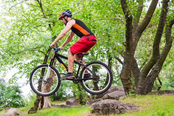 Fototapeta na wymiar Extreme cycling, a cyclist jumping on a mountain bike.