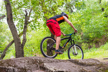 Fototapeta na wymiar Concept of an active lifestyle, a cyclist riding the rocks.