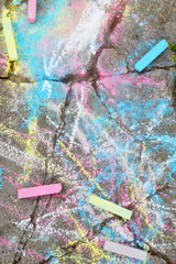 Fototapeta na wymiar Abstract colorful drawing and chalk crayons on old grunge cracked concrete sidewalk as textured background.