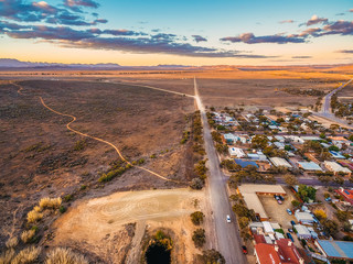 Rural road passing through Hawker - town in South Australia at sunset - obrazy, fototapety, plakaty