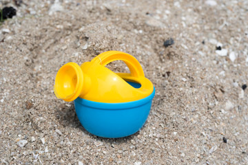 Fototapeta na wymiar Colourful children toys on the sand