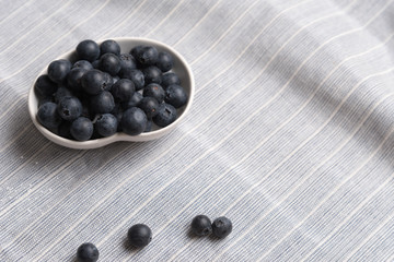 Blueberry fruits in white bowl