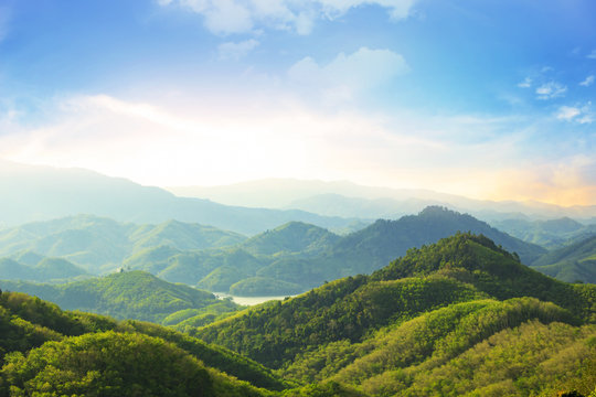 Earth day concept: Beautiful natural scenery of river in southeast Asia tropical green forest with mountains in background