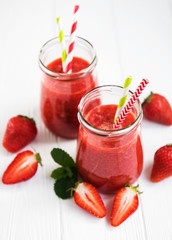 Jars with strawberry smoothie