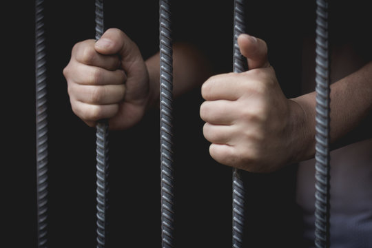 The man was imprisoned in a steel cage, prisoner concept, Hope to be free.