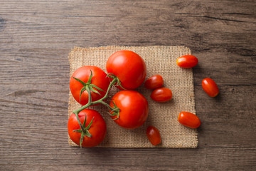 Tomatos on the wooden table.