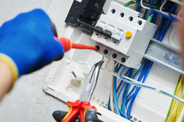 Electrician assembling power switchboard