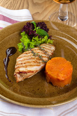 Grilled chicken fillet on plate