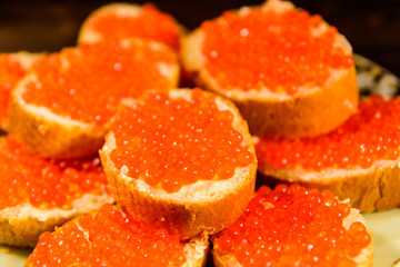 Naklejka na ściany i meble Background of the sandwiches with the red caviar