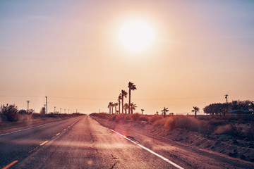 Empty road against the sun, color toned picture, travel concept, USA.