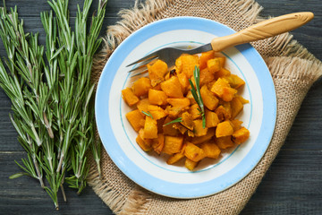Baked pumpkin with rosemary on a plate