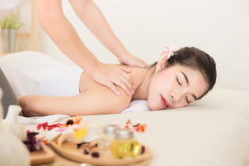 Fototapeta na wymiar Young asian woman enjoying relaxing back massage in spa. Body care, skin care, wellness, alternative medicine and relaxation Concept.