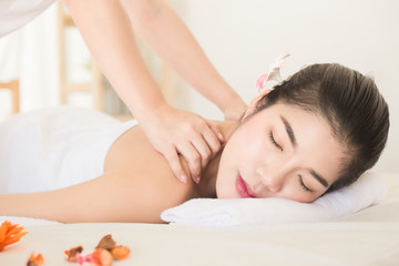 Fototapeta na wymiar Young asian woman enjoying relaxing back massage in spa. Body care, skin care, wellness, alternative medicine and relaxation Concept.