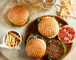 Variety of burgers with fried potato and glass of beer