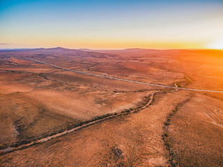 Fototapeta na wymiar Sunset sun flare over alien landscape of Flinders Ranges in South Australia
