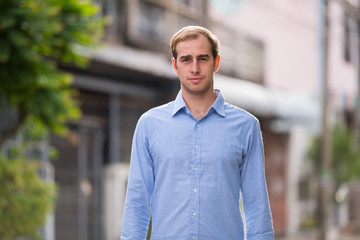Fototapeta premium Young businessman in the streets outdoors