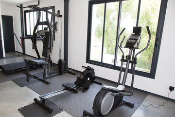 Fototapeta na wymiar Modern Gym Room Fitness Center interior with equipment And Machines