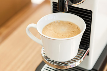 espresso coffee with cup and machine on the wood table